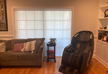 Dining room bathed in soft light through elegant roller window shades.